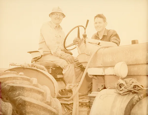Photo Restoration Dad and son on tractor before